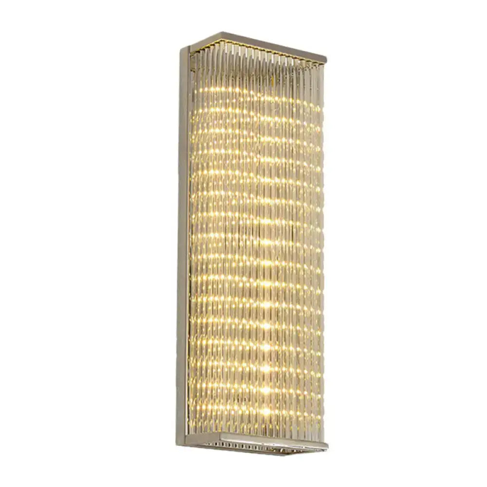 Modern chrome crystal led wall sconce with clear faceted glass crystals emitting warm glow for living room or bar light