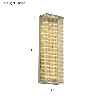 A sleek 16-inch tall modern chrome led wall sconce with crystal rods emitting warm light for living room or bar use