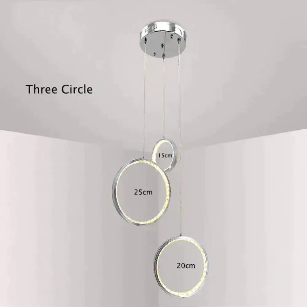 Modern chrome-finished pendant light featuring illuminated crystal rings led for indoor bedroom and dining room use