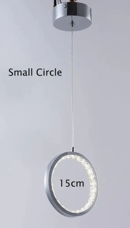 A modern chrome pendant light with crystal rings led inner ring for indoor use in bedroom and dining room