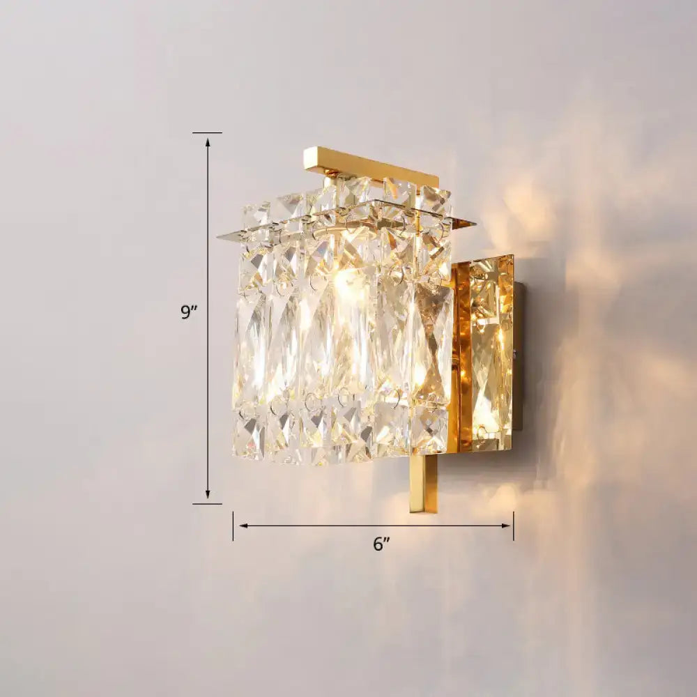 Modern gold-toned wall mount sconce light with cascading clear crystal shade prisms for elegant bedroom lighting