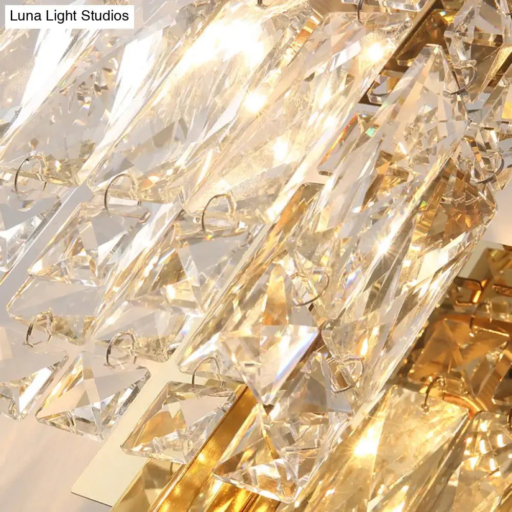 A modern chrome crystal shade sconce light wall mount featuring luxurious faceted clear crystals and gold accents