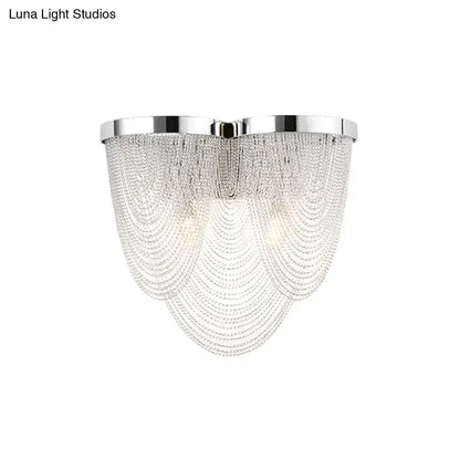 Modern chrome crystal tassel wall light with polished frame and cascading clear beads for bedroom lighting