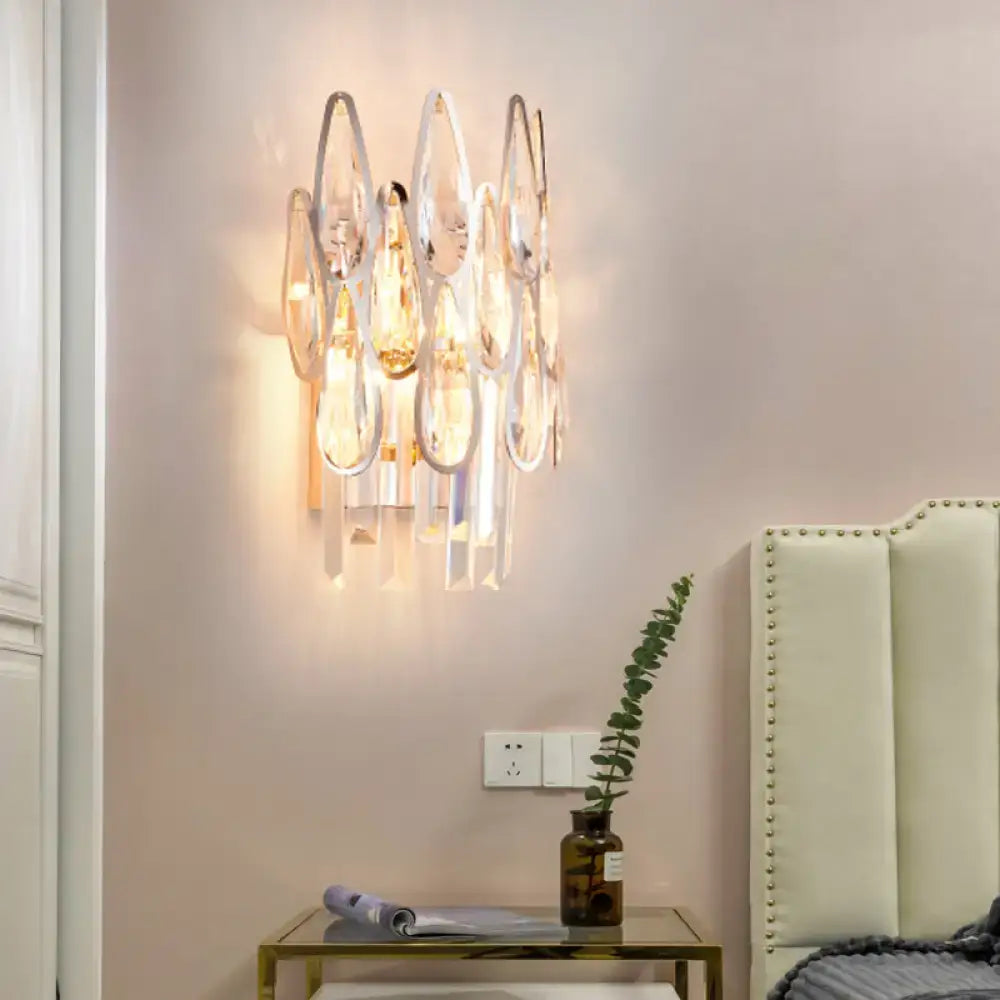 A modern chrome crystal teardrop wall sconce with clear crystals for living room 110v-120v lighting