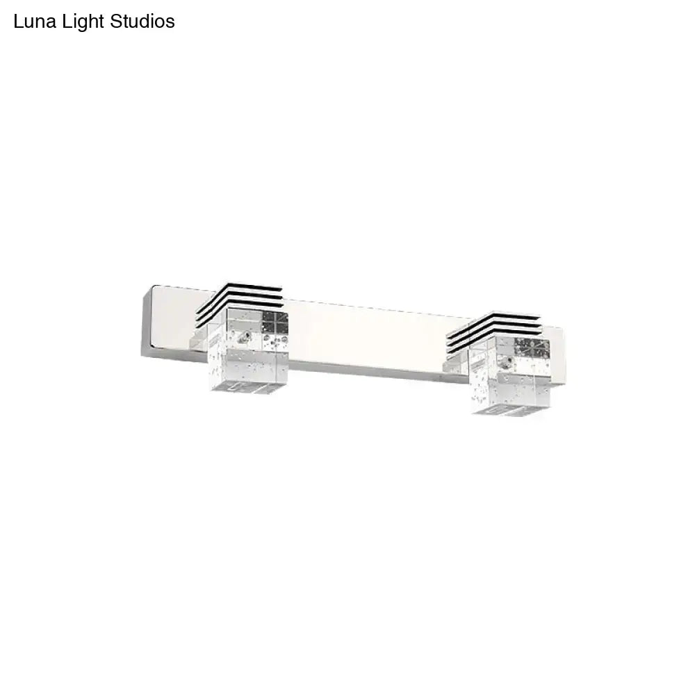 Modern chrome crystal vanity light fixture with two clear cube-shaped led lights and black horizontal stripe accents
