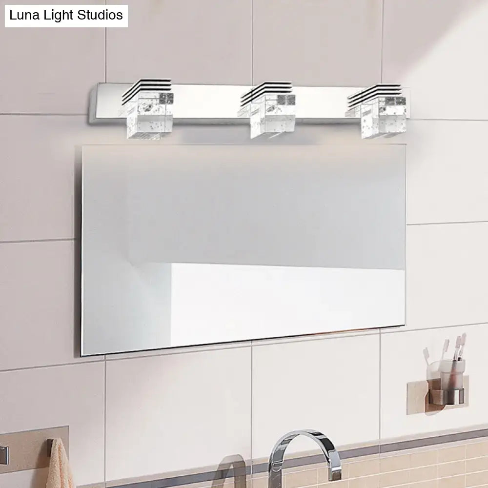Modern chrome crystal vanity light fixture with three rectangular crystal-like fixtures for bathroom use