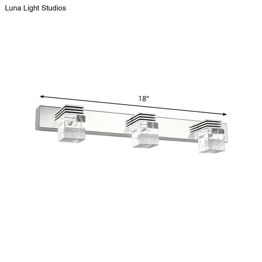 Silver-finished modern chrome crystal vanity light fixture with three clear textured shades and black horizontal accents