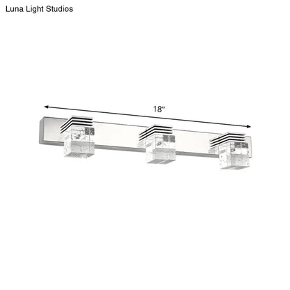 Silver-finished modern chrome crystal vanity light fixture with three clear textured shades and black horizontal accents