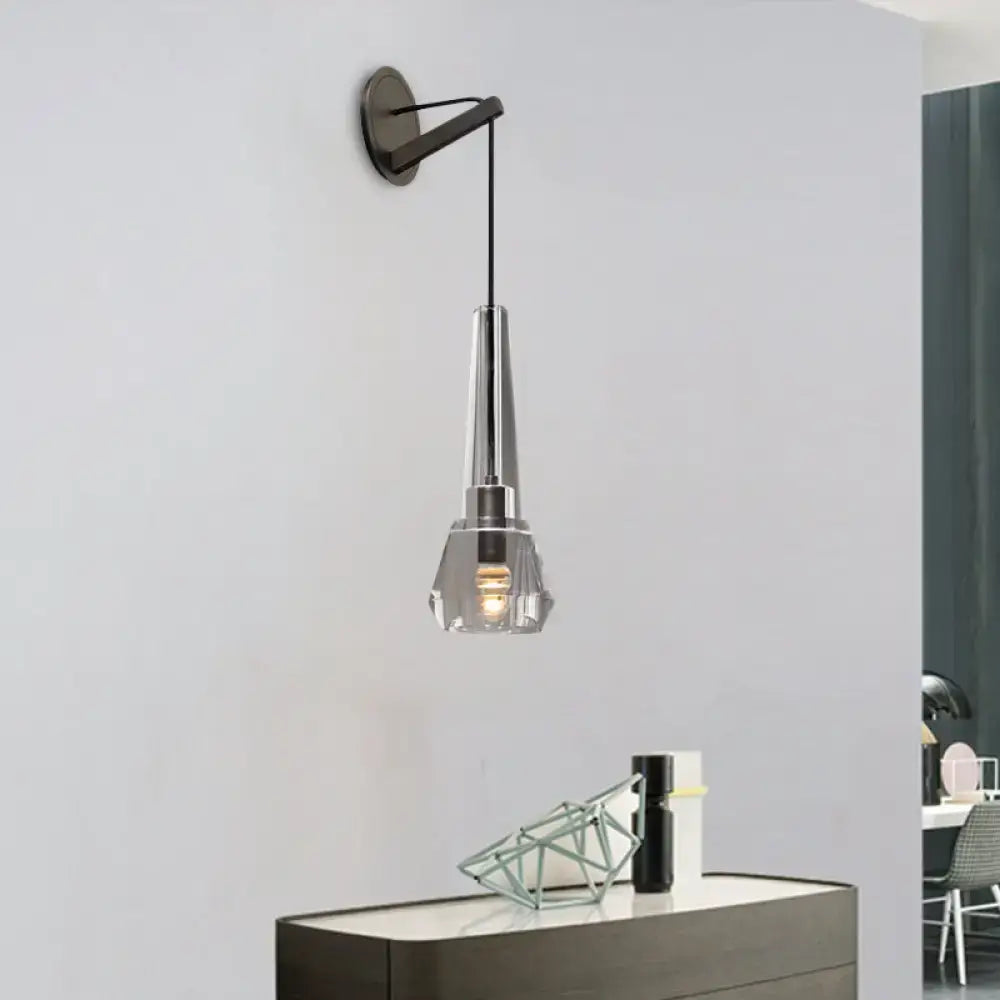 A sleek modern chrome wall lamp with faceted crystal glass shade and dangling cord for bedroom lighting fixture
