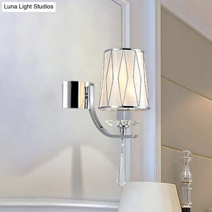 Modern chrome wall lighting fixture with geometric frosted glass shade and crystal teardrop accents for bedroom or hallway