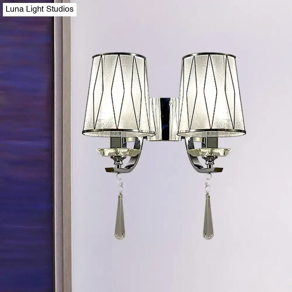 Modern chrome wall lighting fixture with frosted glass shades, geometric black lines, and crystal teardrop pendants