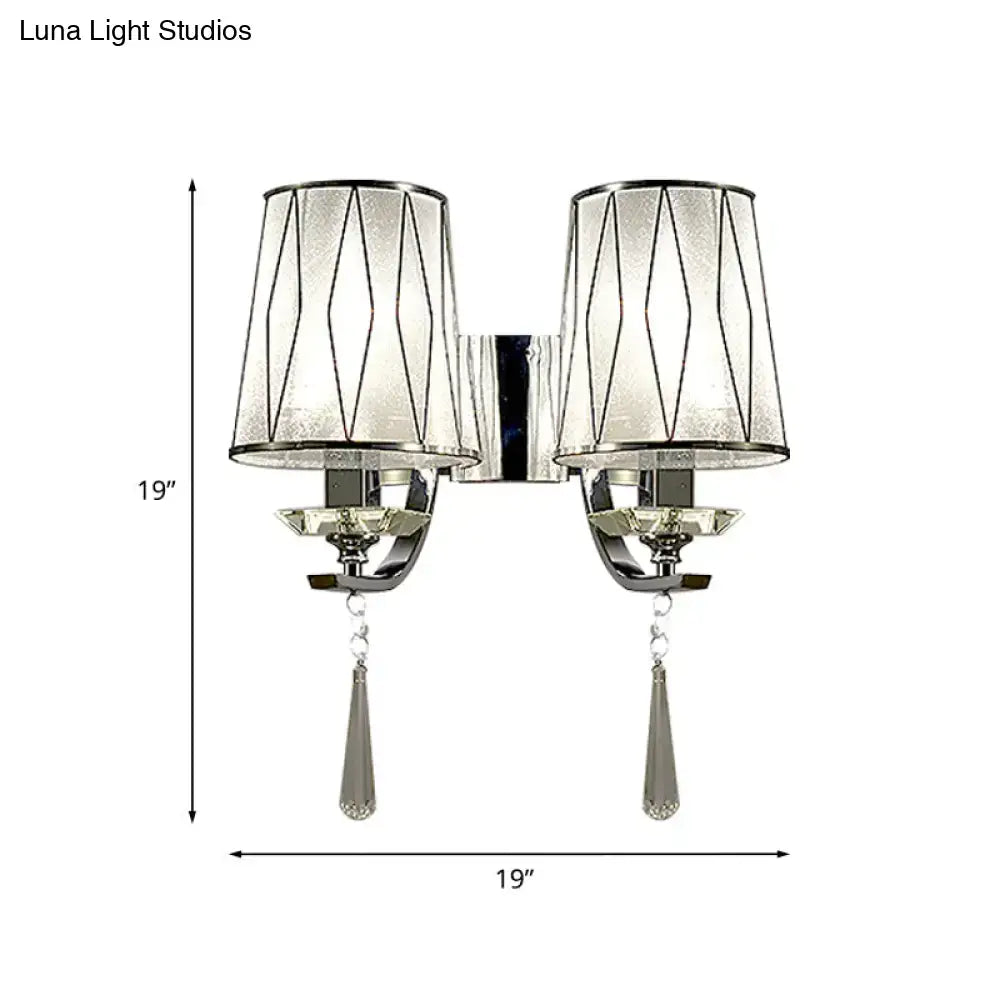 Silver-toned modern chrome wall lighting fixture with double arms, frosted glass shades, geometric wire, and crystal pendants