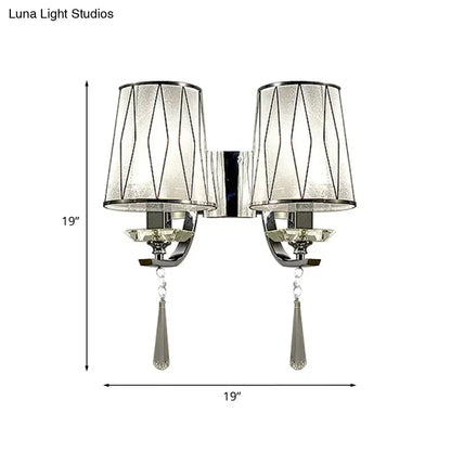 Silver-toned modern chrome wall lighting fixture with double arms, frosted glass shades, geometric wire, and crystal pendants