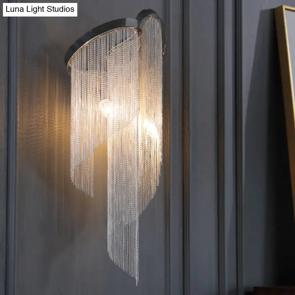 Modern chrome crystal wall sconce with sleek black metal frame and cascading clear crystal beads for bedroom bedside lighting
