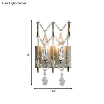 Modern chrome crystal wall sconce light type featuring silver-toned finish with illuminated teardrop pendants and beaded chains