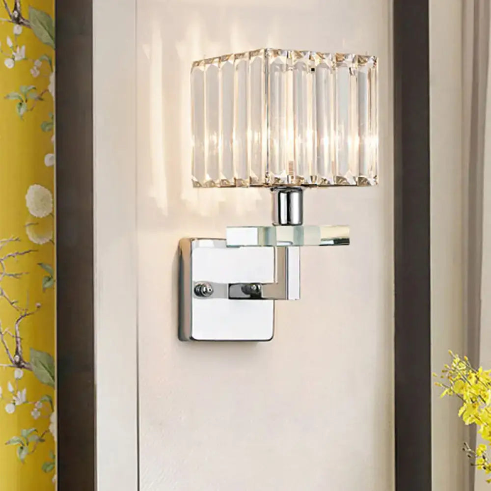 Modern chrome cuboid crystal wall mounted light with faceted glass shade and polished metal base for bedroom use