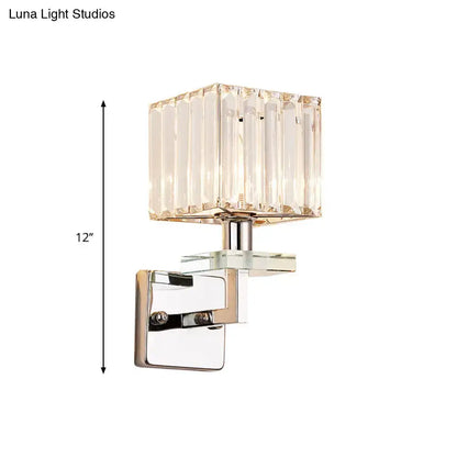 Modern chrome cuboid crystal wall mounted light with a faceted square shade and polished chrome bracket for bedroom use