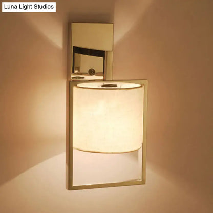 Modern chrome cylinder sconce light fixture with sleek rectangular frame and mirrored backplate for direct wired installation