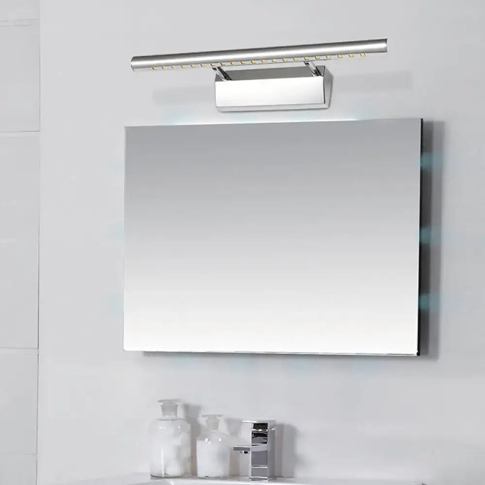 Modern chrome cylinder vanity lighting with integrated LED above a rectangular bathroom mirror in sleek minimalist design