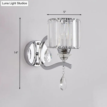 Modern chrome cylinder wall light with faceted crystal block shade and dangling teardrop crystals for bedroom use