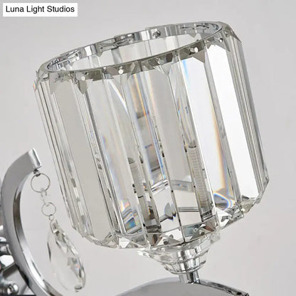Modern crystal block cylinder wall light with faceted crystal shade and polished chrome finish for bedroom sconce