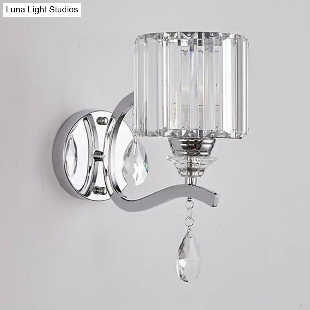 Modern chrome cylinder wall light with faceted crystal block shade and dangling teardrop crystals for bedroom use