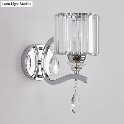 Modern chrome cylinder wall light with faceted crystal block shade and dangling teardrop crystals for bedroom use