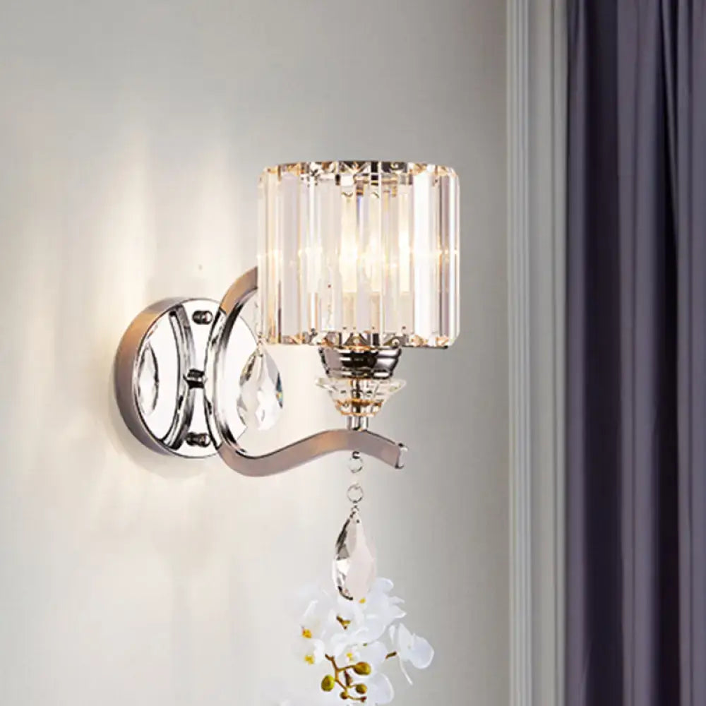 Modern chrome cylinder wall light with crystal block shade and white orchid ornament for bedroom use