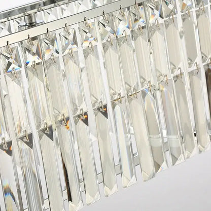 A modern chrome decorbites crystal chandelier with clear faceted rectangular prisms for dining room lighting