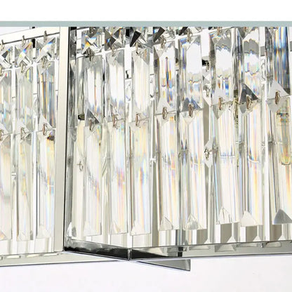 A modern chrome decorbites crystal chandelier with clear faceted glass prisms for dining room lighting