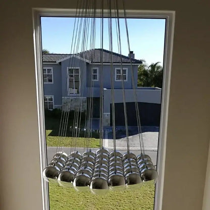 Modern chrome decorbites crystal glass ball pendant light with spherical cascading design for living room lighting