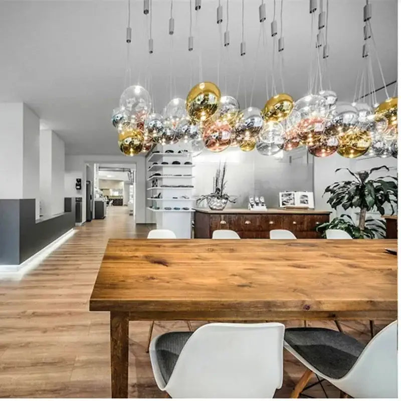 Modern chrome decorbites glass ball pendant light featuring spherical bulbs in gold rose gold and silver finishes