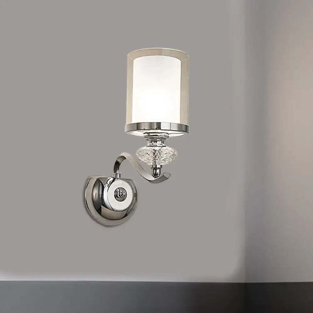Modern chrome dual cylinder bathroom sconce with curvy arm featuring frosted glass shade and faceted crystal accent
