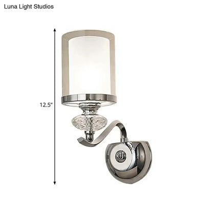 Modern chrome dual cylinder bathroom sconce with curvy arm featuring cylindrical frosted glass and crystal accent fixture height