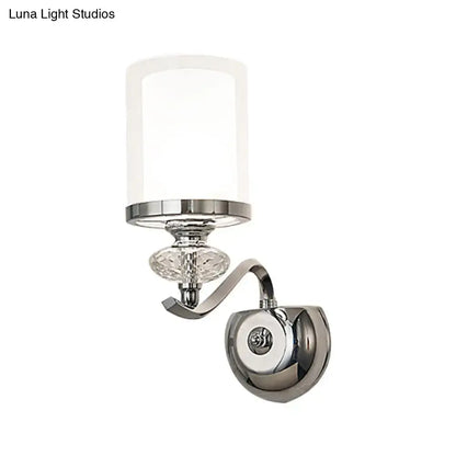 Modern chrome dual cylinder bathroom sconce with frosted glass shade, crystal accent, and curvy arm fixture height detail