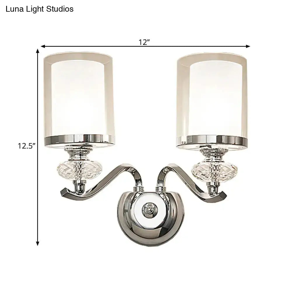 Modern chrome dual cylinder bathroom sconce with curvy arm silver finish crystal accents and frosted glass shades fixture height