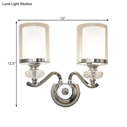 Modern chrome dual cylinder bathroom sconce with curvy arm silver finish crystal accents and frosted glass shades fixture height