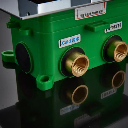 Modern chrome dual handle shower mixer valve back side with green plastic body brass fittings and labeled cold mixed water ports