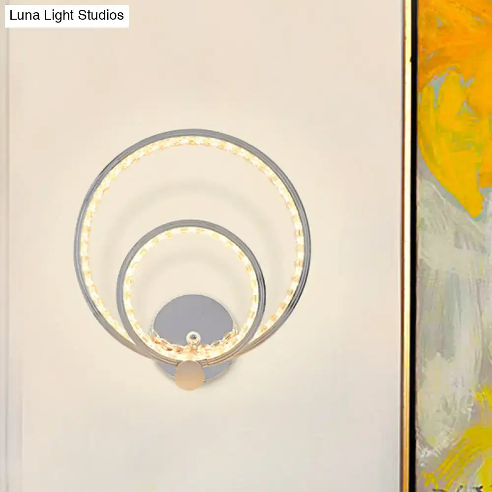 Modern chrome dual ring led wall mounted light fixture with two concentric circular rings for bedroom use