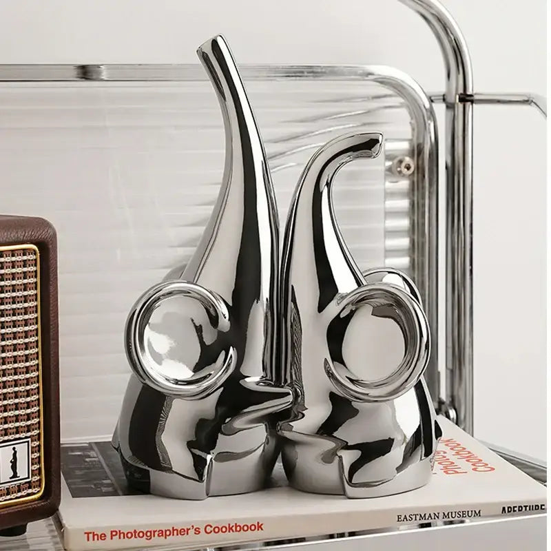 Shiny chrome ceramic decorbites elephant sculpture bookends with sleek modern design and circular ear details for living room decor