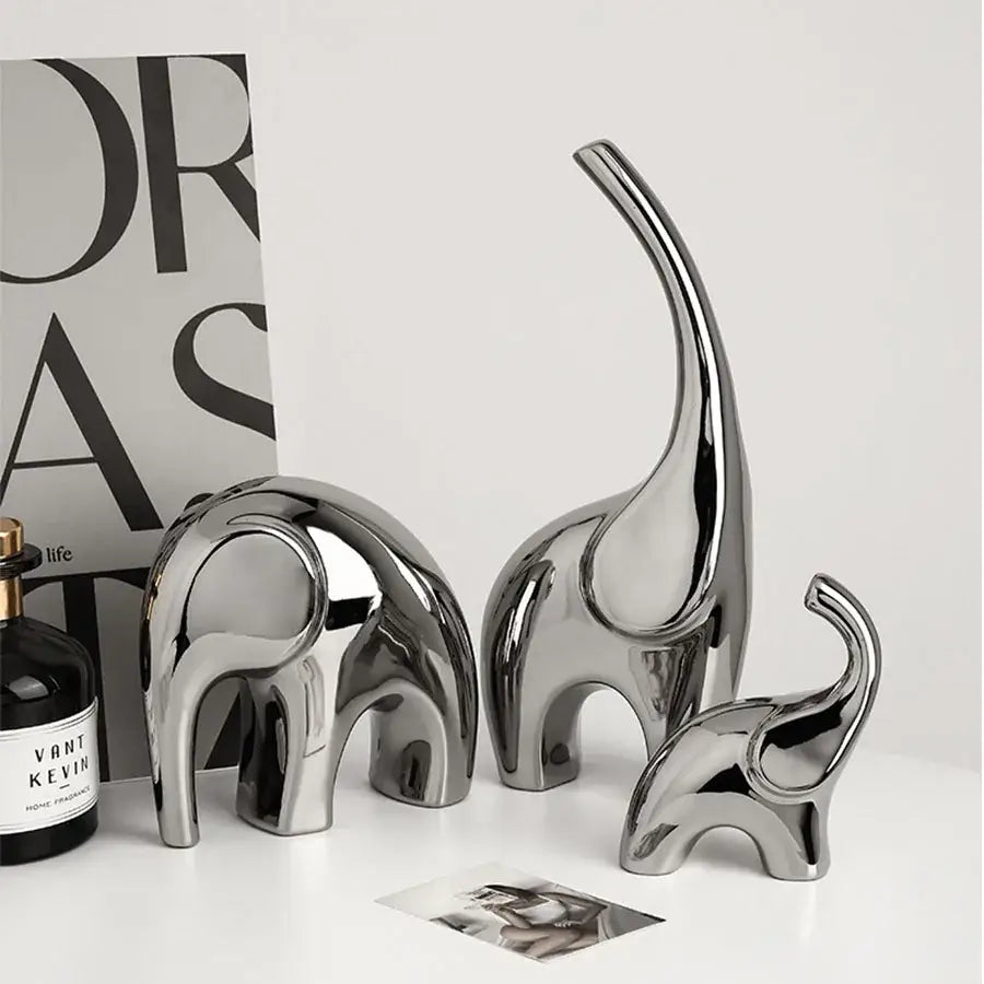 Set of three sleek metallic silver ceramic elephant sculpture bookends with smooth reflective surfaces for living room decorbites elephant sculpture