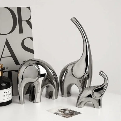Set of three sleek metallic silver ceramic elephant sculpture bookends with smooth reflective surfaces for living room decorbites elephant sculpture