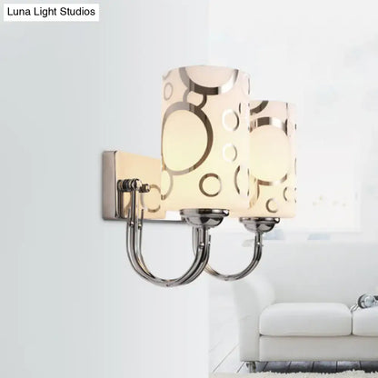 Modern chrome finish two-light wall sconce with frosted glass shades and gold-toned circle pattern 110v-120v