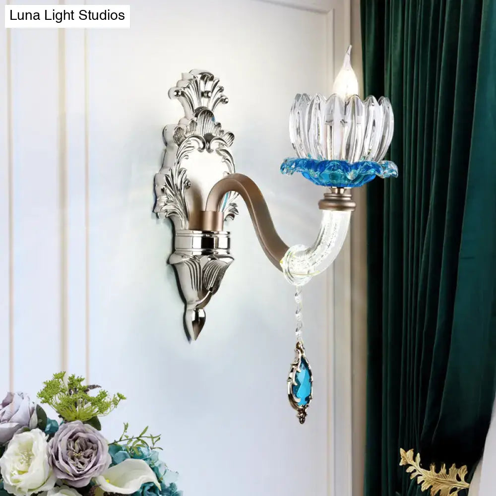 Elegant modern chrome finish clear glass wall light with silver frame and blue crystal accent for bedroom sconce