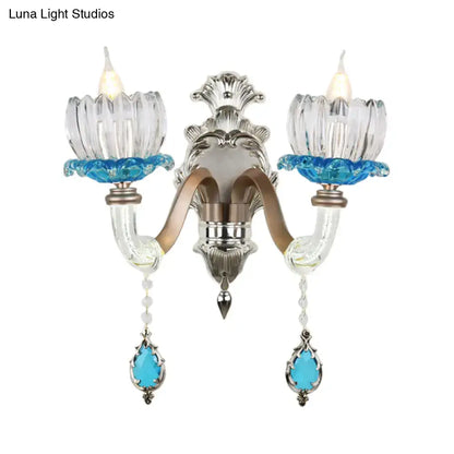 Modern chrome finish clear glass two-light wall light with silver and blue accents for bedroom use