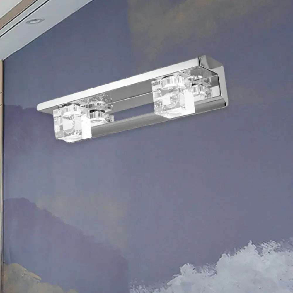 Modern chrome finish vanity sconce with warm white light and three clear crystal cube accents for bathroom use