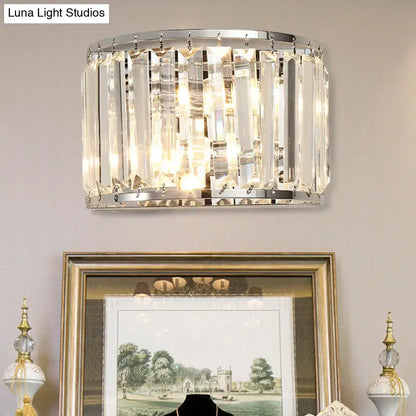 Modern chrome finish crystal wall lamp with clear crystal prisms in a sleek cylindrical design for bedroom use