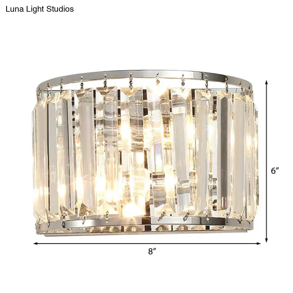 Modern chrome finish wall lamp with clear crystal vertical prisms mounted on polished rings for bedroom lighting