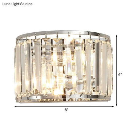 Modern chrome finish wall lamp with clear crystal vertical prisms mounted on polished rings for bedroom lighting