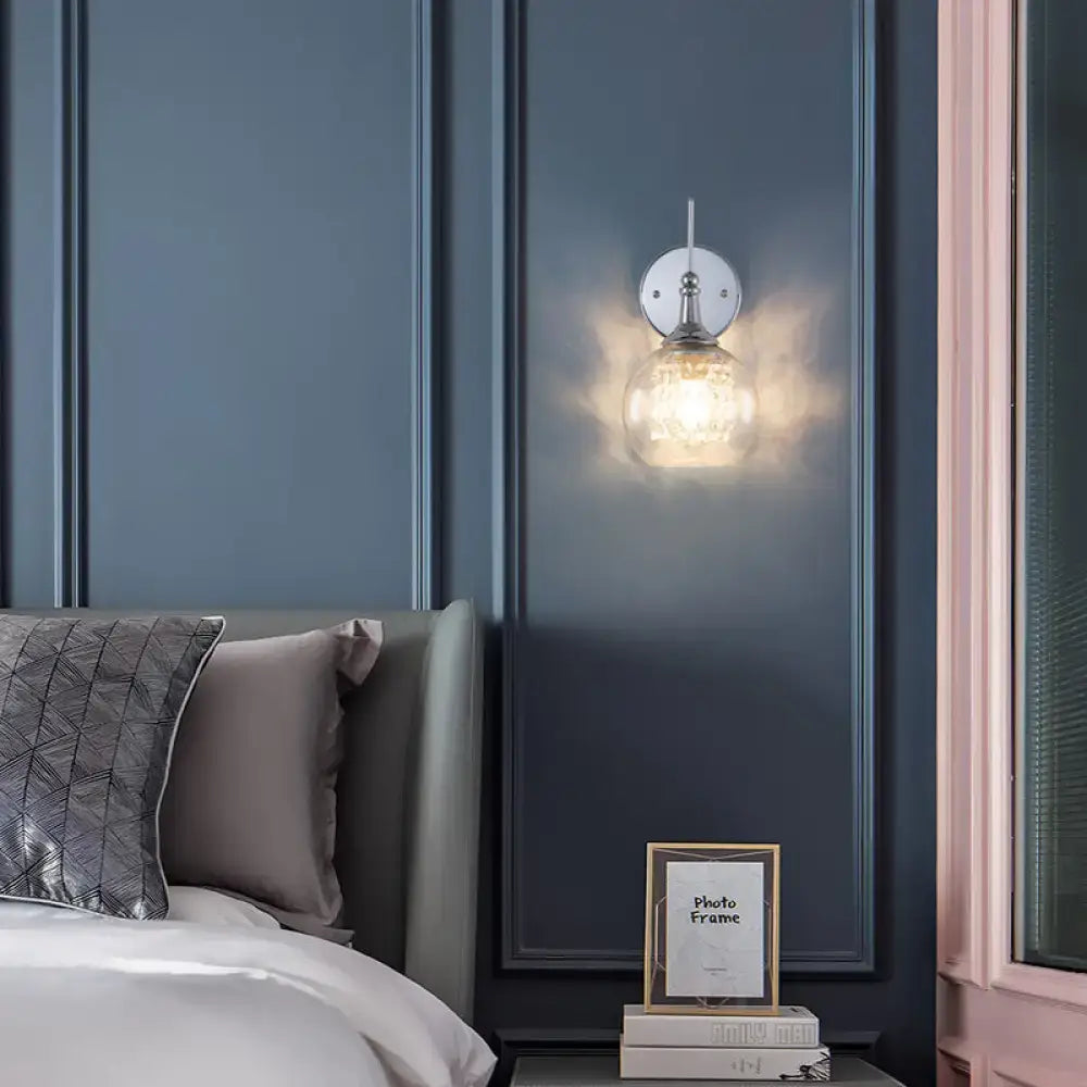 Modern chrome finish wall lamp with a sleek chrome finish and crystal inner glass for a modern touch in the bedroom